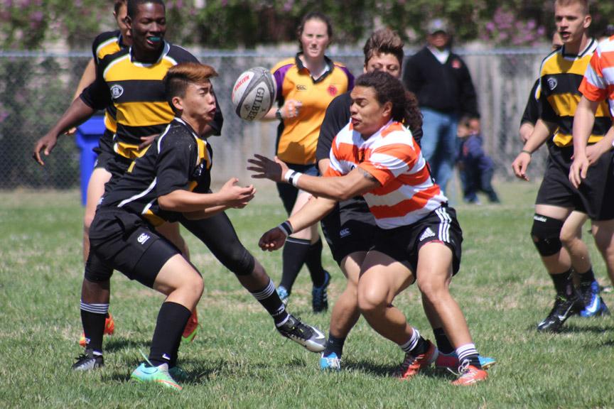 Phillip Soh prepares to the rugby ball against the KC Cougars.
