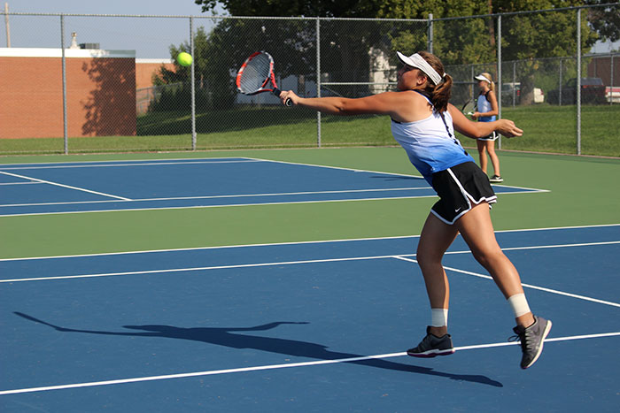 Senior+Jordan+Dombrowski+returns+the+tennis+ball+with+a+backhand+hit.+Dombrowski+and+doubles+partner+Codi+Post+qualified+to+compete+in+the+Girls+6A+State+Tennis+Tournament.+
