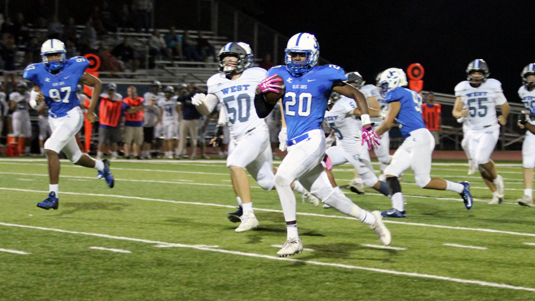 Lucio Norris runs the ball back for a touchdown after his interception against Olathe West. 