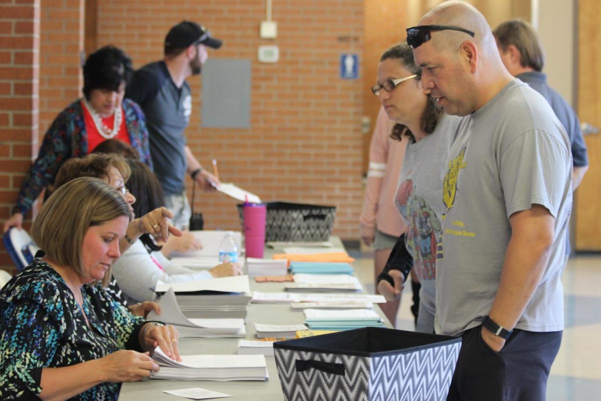 Parents check in during parent teacher conferences on September 28, 2017. 