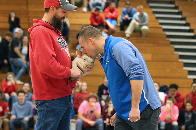 Mr. Katt kissing a pig at the February 13 home basketball game. 