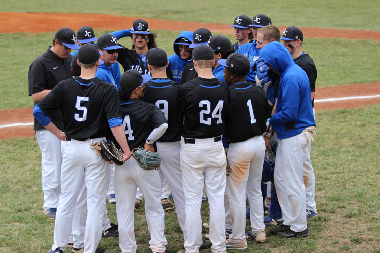 The baseball team takes a huddle after a inning at the home baseball game April 24th against Seamen. 