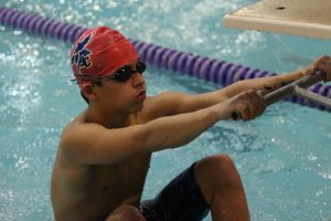 Junior Adrian Robles prepares for a backstroke start at a meet in Manhattan on January 9, 2019. 