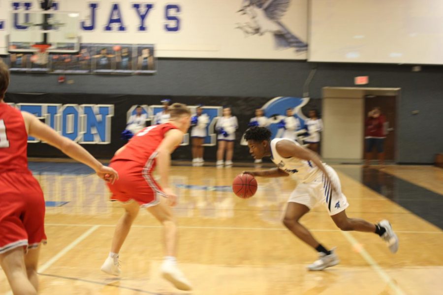 Senior AJ Dickerson drives to the basket on Saturday February 2nd against Emporia Spartans. 