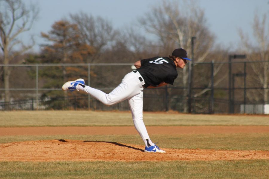 Senior Thane McDaniel pitches the ball on March 21st against Topeka High. 