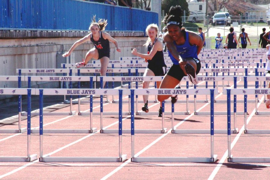 Keiana Newman, two-time state champion in the 100-meter hurdle, competes in hurdles at the home track meet on April 9, 2019.