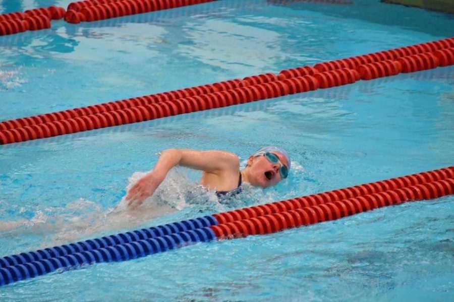 Junior swimmer Sarren Hines  swims the 50 M freestyle in the triangle against Manhattan and Topeka High School last Tuesday, March 29 at the Topeka Natatoriam. She placed first with a time of 28.93 seconds. 