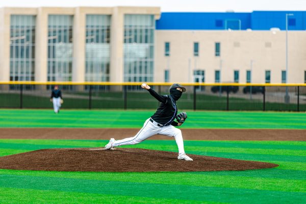 Senior pitcher Conrad Gomez throws toward home plate.